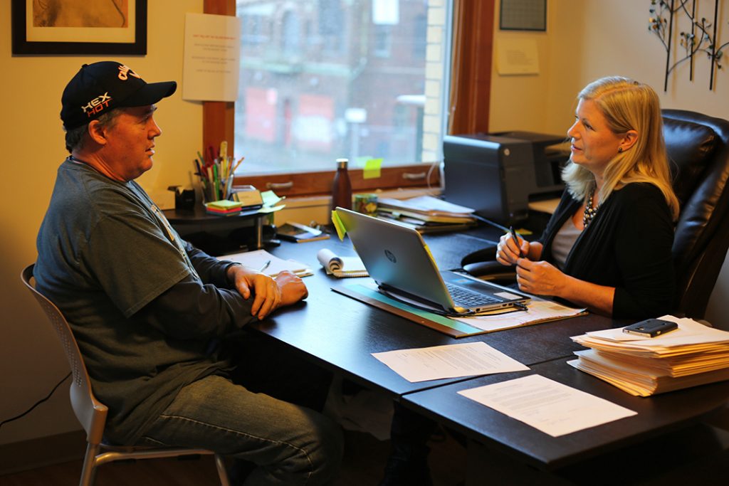 Case Manager Kristi Katzke meets with a resident of Blanchet House.