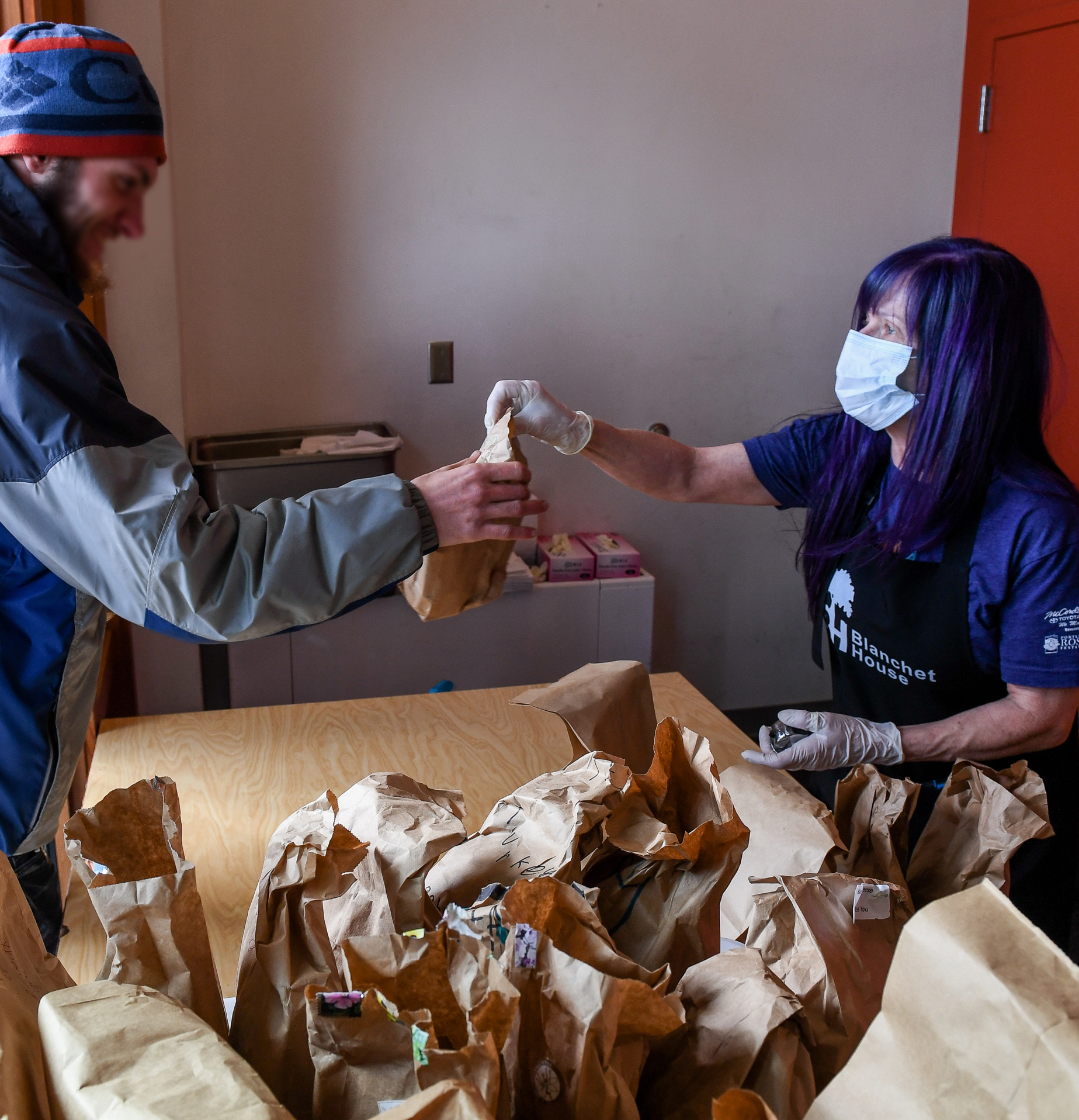 Josi Whitney volunteers to serve lunch at Blanchet House of Hospitality during the COVID19 pandemic in Portland, Oregon. Photo by Justin Katigbak.