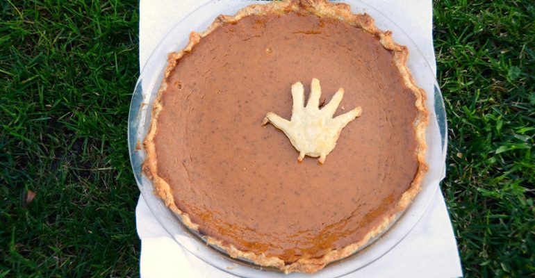 Pumpkin pie with turkey hand decoration