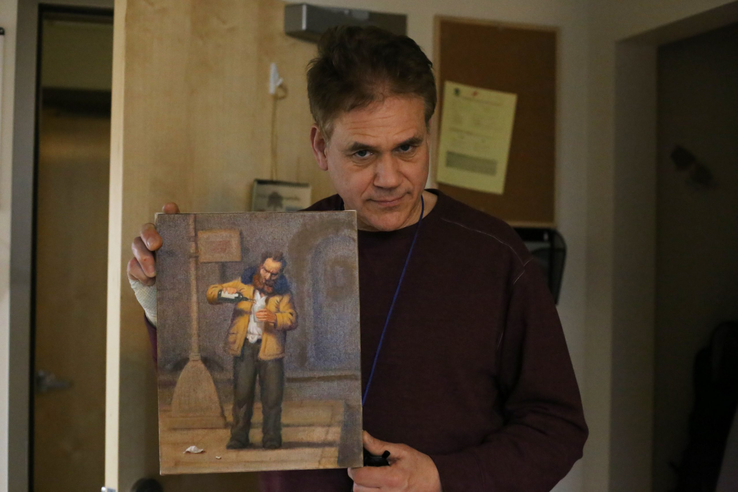 Artist Richard Lithgow poses with a recent painting he made at Blanchet House.
