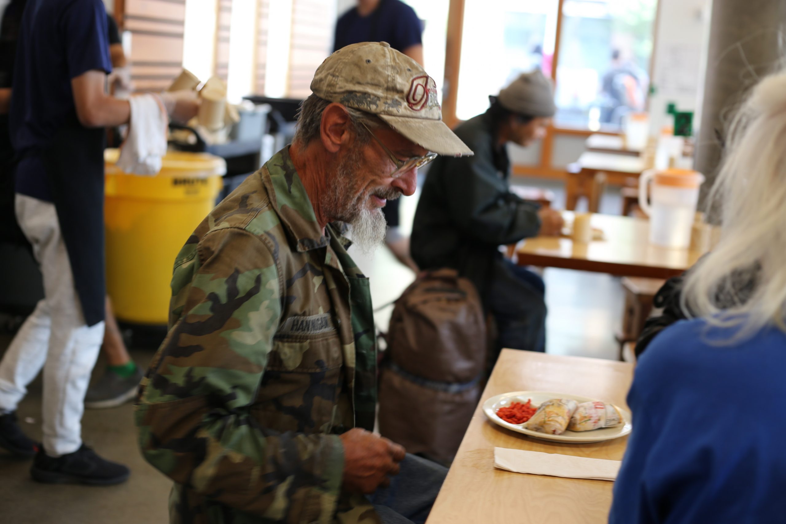 A Veteran enjoys a free meal at Blanchet House in downtown Portland, Oregon.