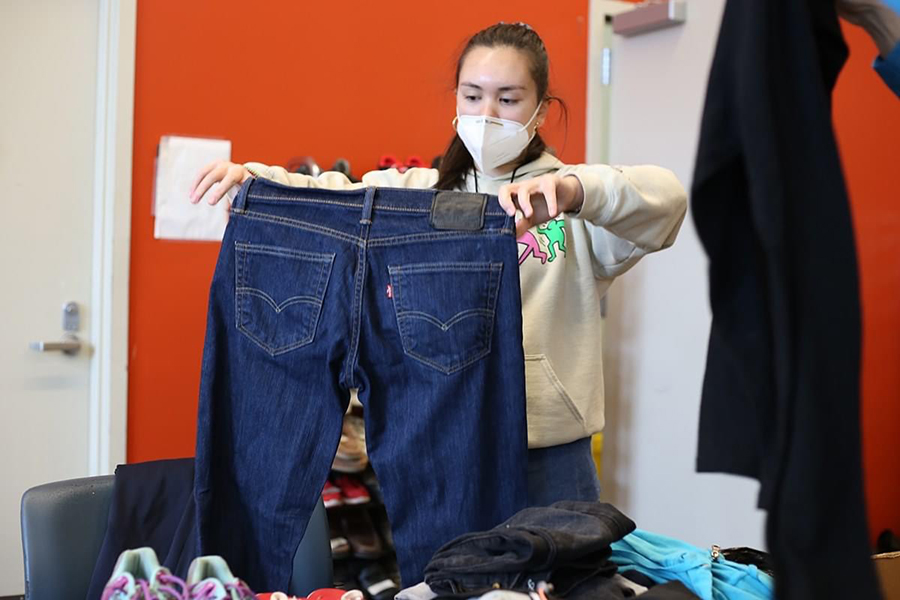 A volunteer sorts donated clothing at Blanchet House.