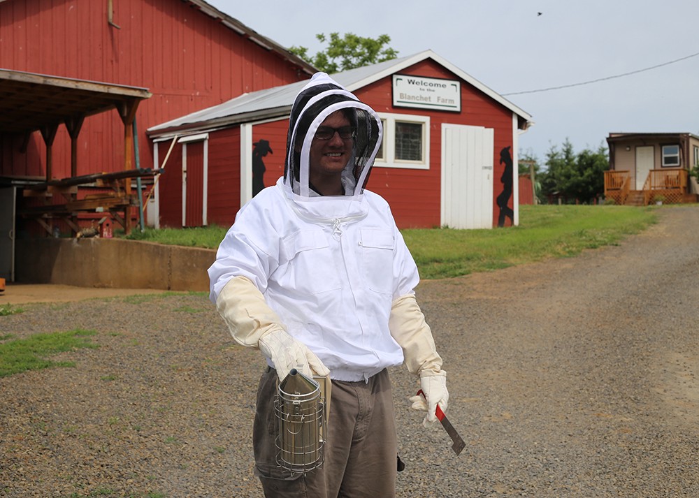 Jordan S., a beekeeper in training, at Blanchet Farm. Photo by Julie Showers.
