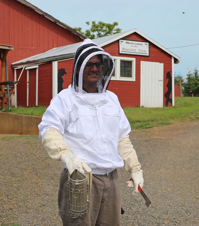 Man in beekeeping suit at Blanchet Farm