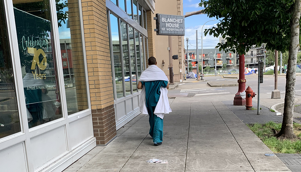 Homeless woman walking in hospital scrubs