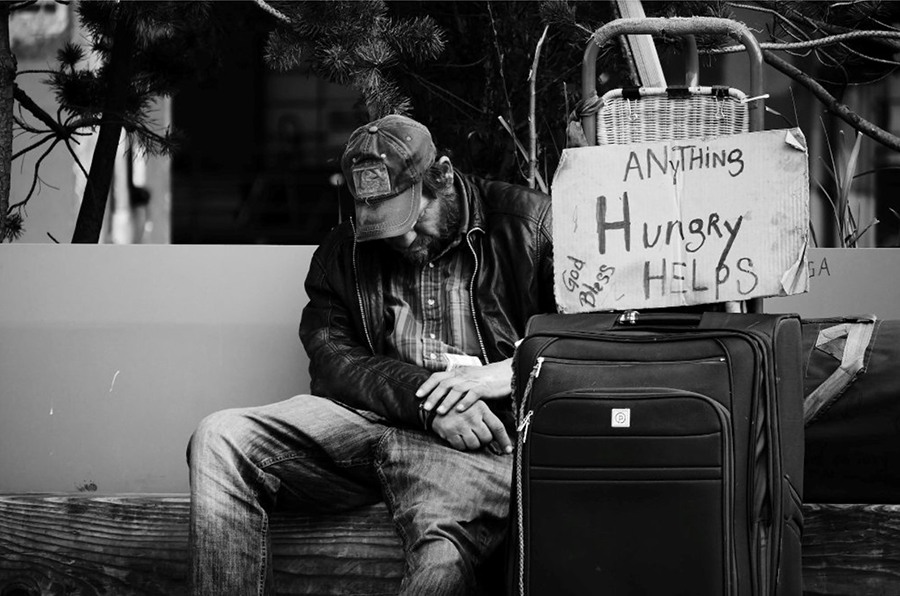Homeless man with bags Trauma Can Lead to Homelessness