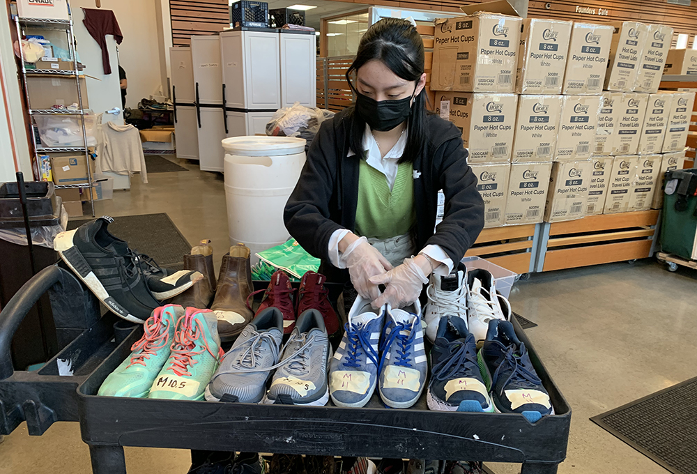 Volunteer with donated shoes