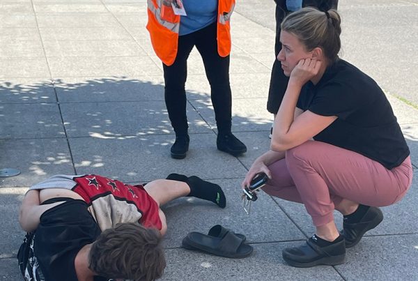 Ban of homelessness, Nurse Emily Harrington volunteers to aide a woman in pain on the sidewalk outside Blanchet House.