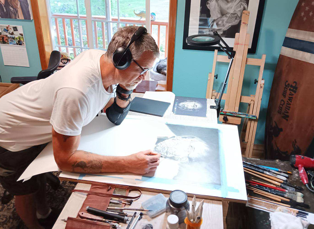 Rob Moody works on a drawing in his studio.