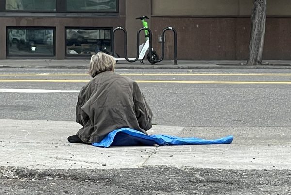 homeless older adults on sidewalk