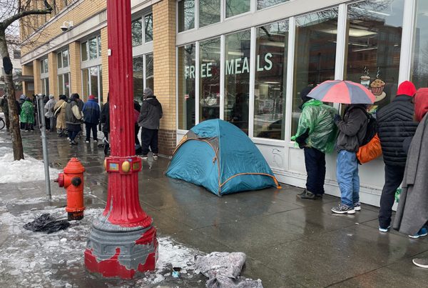 Line of people wait for meals which reflects the increase in homelessness reported in the 2023 Point in Time count