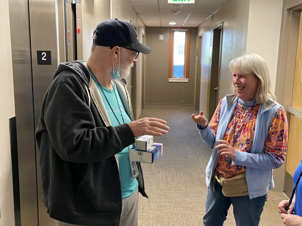 Katie Hennessy talks with a resident at Blanchet House.
