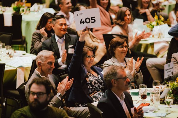 Oregon First Lady Aimee Kotek Wilson raises her hand to donate at Blanchet House's Lend a Helping Hand Brunch on March 2, 2025.