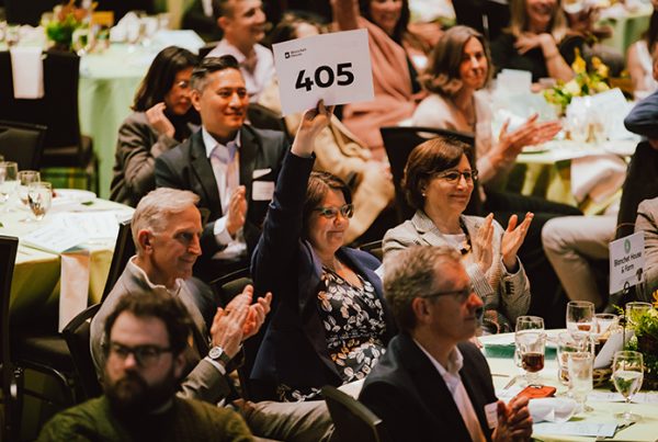 Oregon First Lady Aimee Kotek Wilson raises her hand to donate at Blanchet House's Lend a Helping Hand Brunch on March 2, 2025.